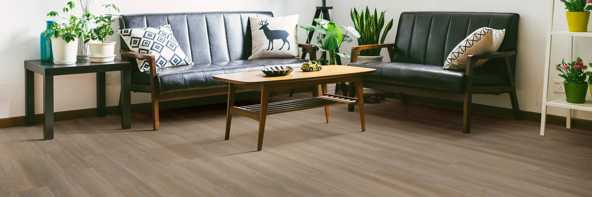 black leather couch and coffee table on brown vinyl floor from Anderson Flooring Centre, Inc. in Winnipeg, MB